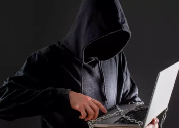 male hacker with laptop protected by chain 65cc74af5acd2