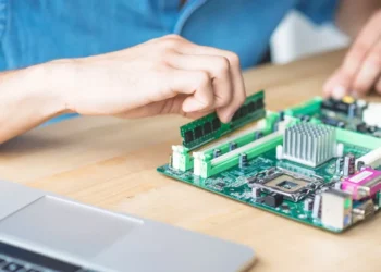 it technician repairing hardware equipment s wooden table 68ece88b6defd