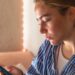 teenage girl with phone bed morning gadget addiction adolescence