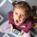 portrait little girl upset because game